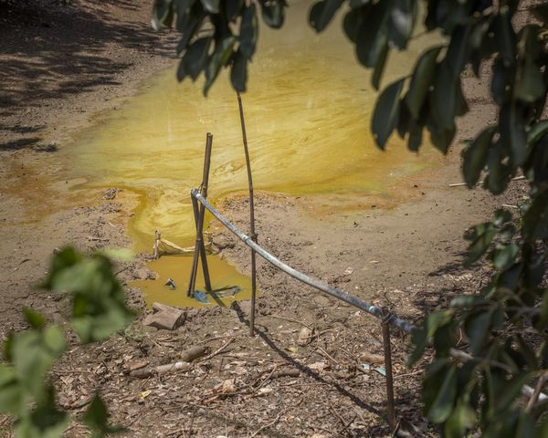 © Ponita Keo - The Kan family's depleted rain-fed water reservoir often used to clean and care for livestock.