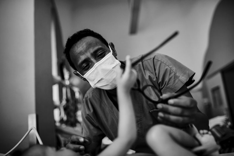 © Carlo Perazzolo - Local nurse plays with a baby in PIC ward, after interventions