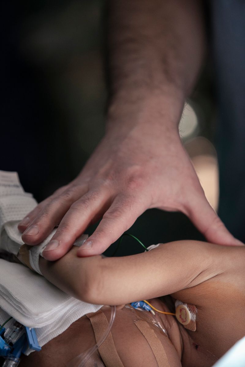 © Carlo Perazzolo - Surgeon and a baby ready to go under surgery.