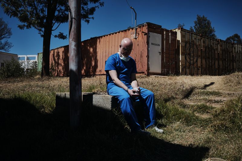 © Carlo Perazzolo - Italian surgeon chills outside the ward after a difficult operation