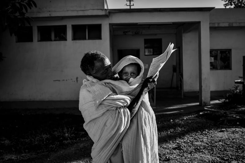 © Carlo Perazzolo - Local grandfather carry his grandson to screening, after the trip to reach Asmara hospital from afar.