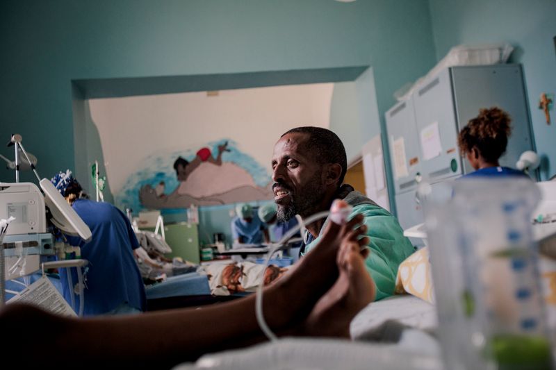 © Carlo Perazzolo - A father waits for his son to wake uo after a successful heart surgery operation.