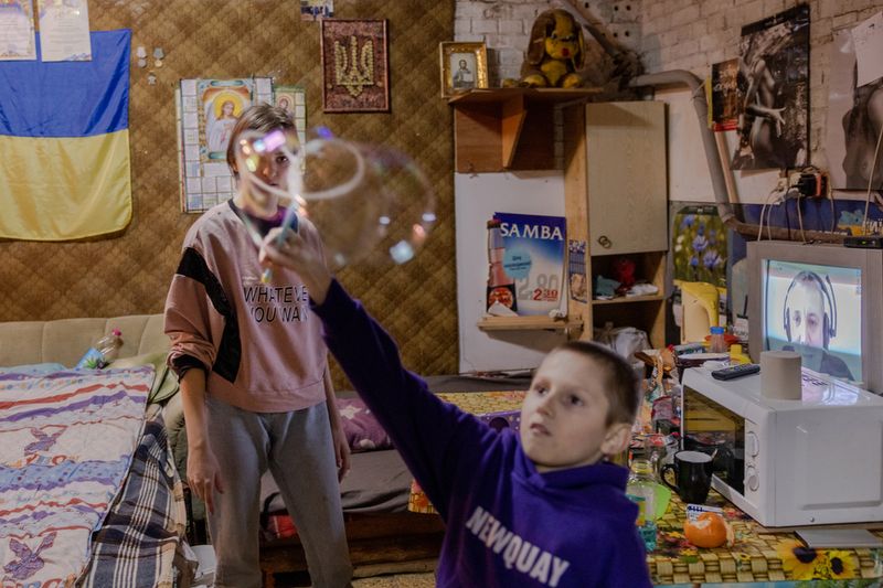 © Natalie Keyssar - Children play in a bomb shelter Kyiv while it was encircled by Russian forces.