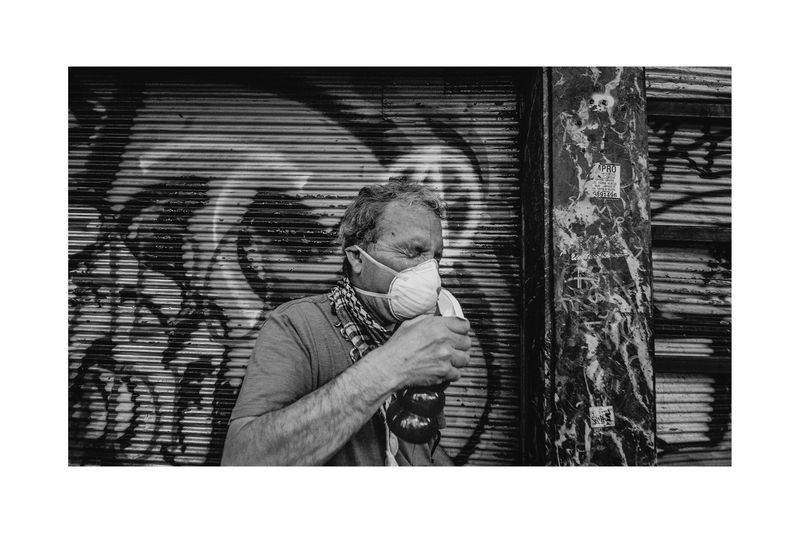 © Matias Cortez - a man cover himself with bicarbonated water because of the tear gas