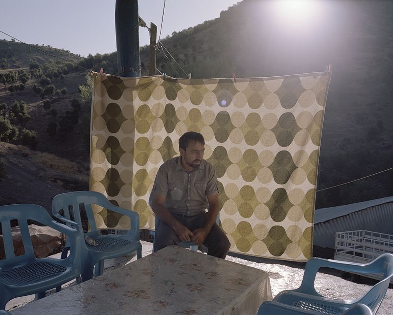 © Miriam Stanke - The mayor of a little village which will be flooded due to the Pembelik dam project, sits in front of his house