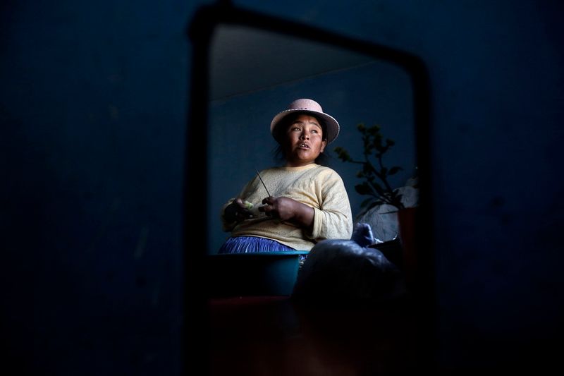 © Olmo Calvo - Zenobia Mamani Ramos, 38 years old, 38 weeks pregnant, cooking in her house in Patacamaya. September 12th 2013