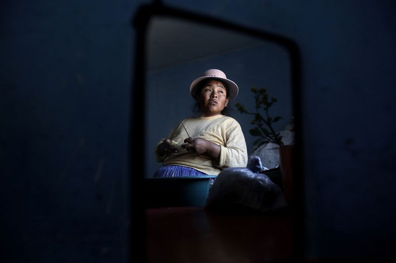 © Olmo Calvo - Zenobia Mamani Ramos, 38 years old, 38 weeks pregnant, cooking in her house in Patacamaya. September 12th 2013