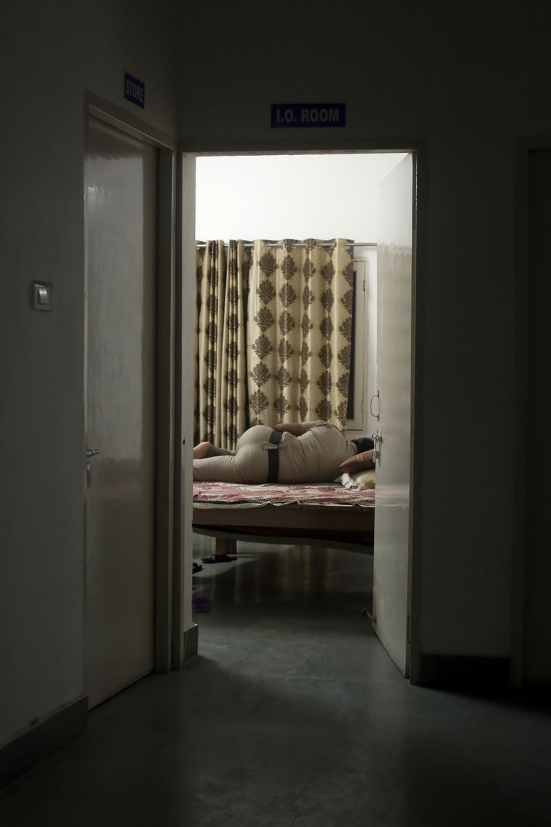 © Melanie Dornier - Rest room, AWPS, Gurugram, Haryana, India, 2016.Constable Bhateri is resting at night.
