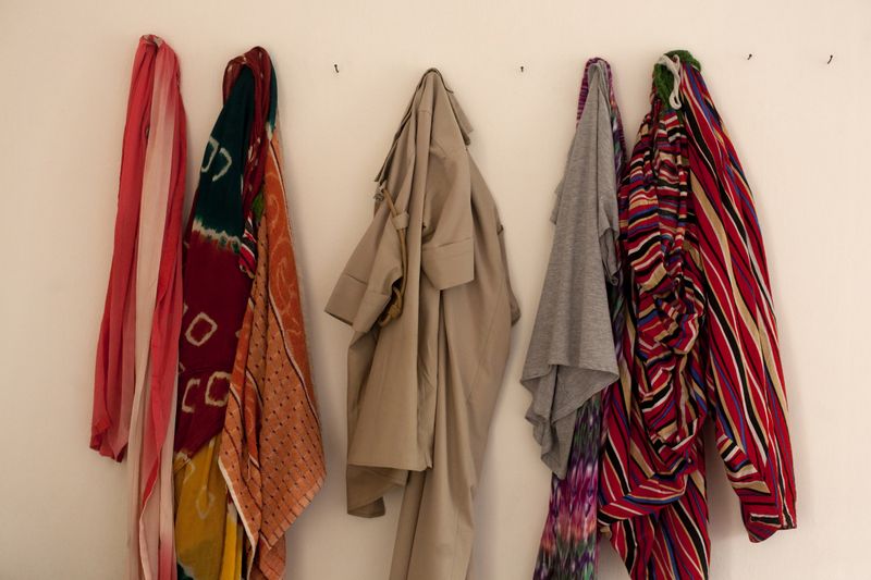 © Melanie Dornier - Personal effect, AWPS, Gurugram, Haryana, India, 2016.In the women’s rest room, some clothes and uniform are hanging.