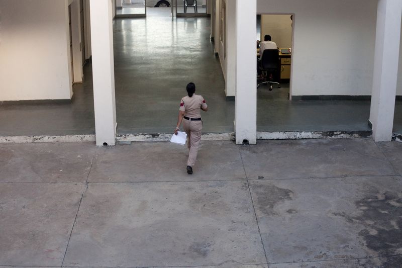 © Melanie Dornier - Inside view of AWPS, AWPS, Gurugram, Haryana, India, 2016.Assistant Sub Inspector Kiran crosses the courtyard of the AWPS.