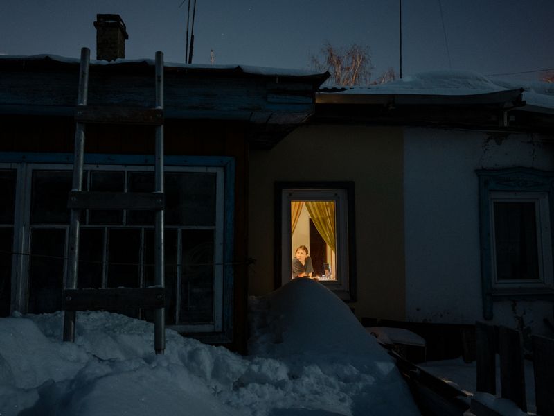 © Aliona Kardash - Mom in the window of my parents' house. At the end of winter there is so much snow that it reaches the window sill. 19.02.22