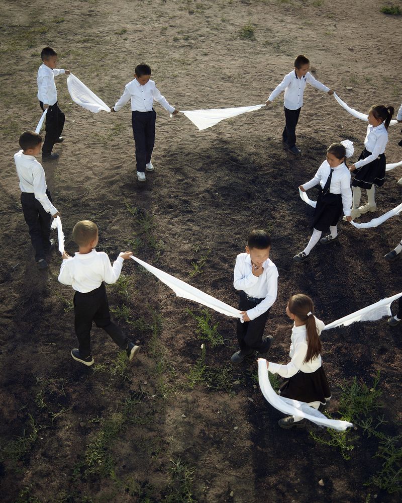 © Louise Amelie - White Road. Young Hands. School kids during break in Tong.