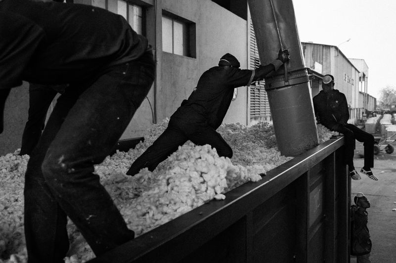 © Jost Franko - Workers vacuum cotton from containers in Sofitex factory in Hounde, Burkina Faso, on December 8th 2015.