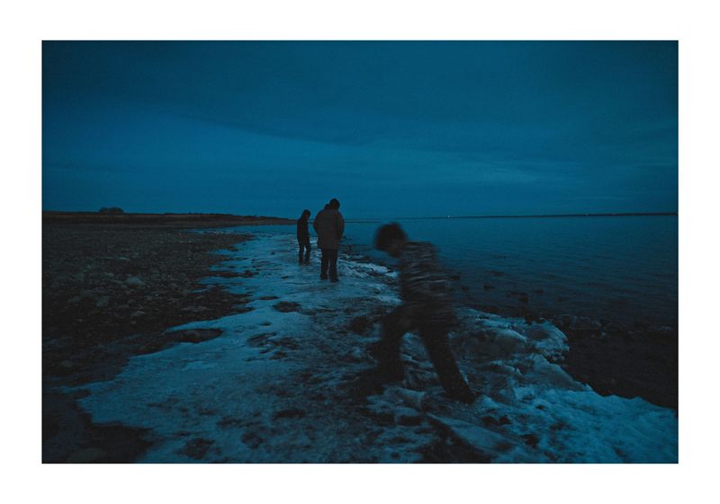 © Noam Azouz - children playing on the frozen shores of lake sakagawea, ND