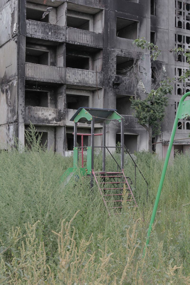 © Nazar Furyk - 5. Children's playground in front of a damaged residential building in Borodyanka. August, 2022.
