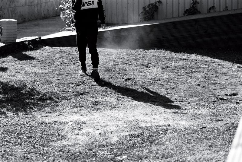© Ksenia Shupenya - Movement caught in stillness - a figure, a shadow, suspended mid-step. Ilford Delta 100