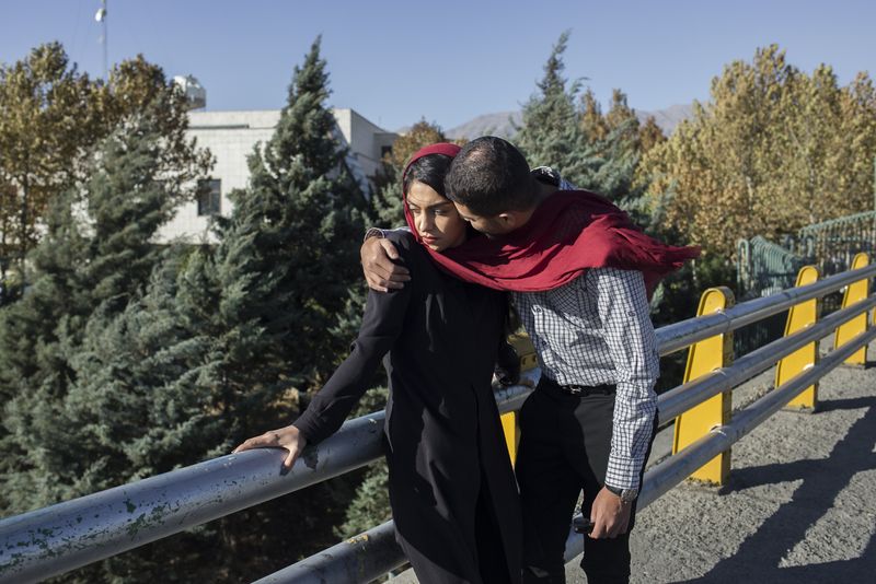 © Parisa Azadi - OCTOBER 13, 2017 - Negar and her friend Hussain embrace each other on the streets of Tehran, Iran.