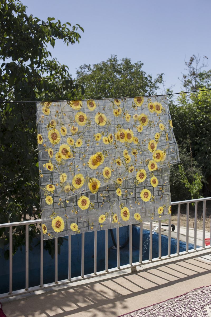 © Parisa Azadi - SEPTEMBER 1, 2018 - A plastic tablecloth hangs on a clothesline as it dries in the sun in village of Chenar, Iran.