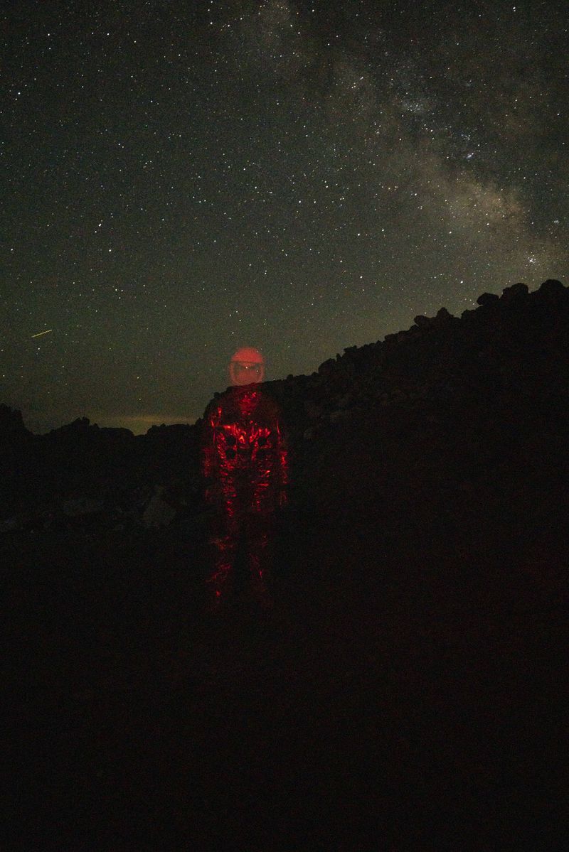 © Mackenzie Calle - A queer person, semi-erased from the world while in an astronaut suit.