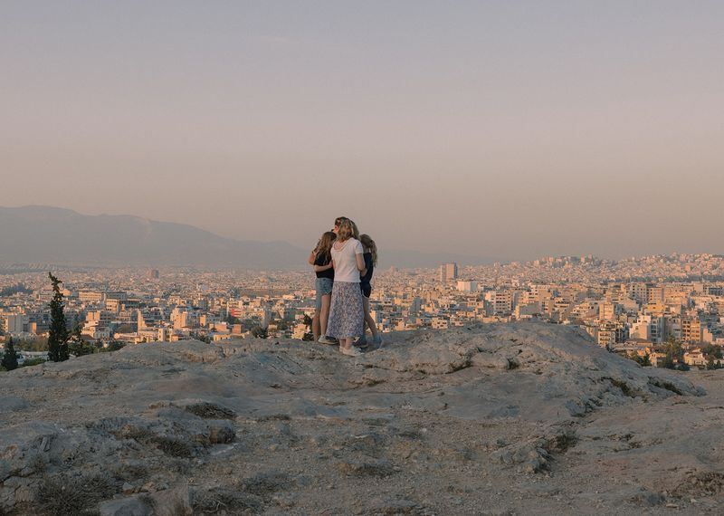 © Michaela Nagyidaiová - A family standing close to each other during sunset, Greece.