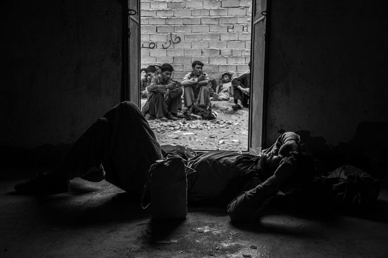 © Zobair Movahhed - Afghan refugees, after having recently crossed the border into Iran, wait to be transported to their next destination.
