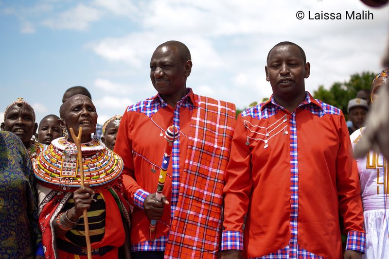 © Laissa Malih - A Samburu woman singing beside Deputy President William Ruto and Samburu Governor Moses Lenolkulal.