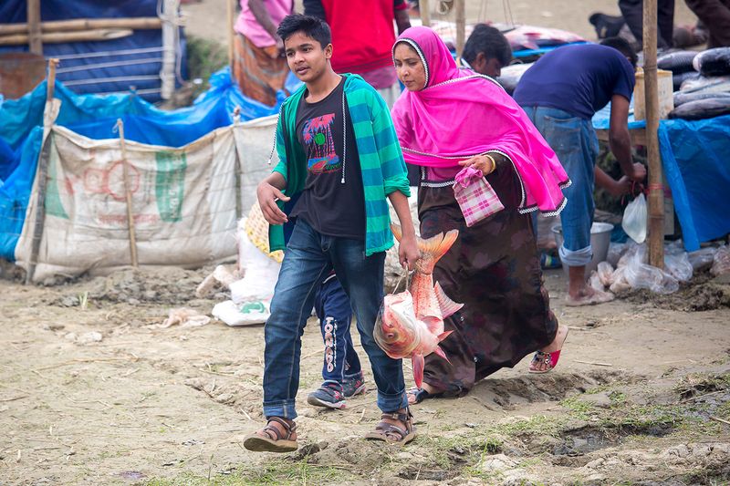 © Jahangir Alam Onuchcha - A young boy and his Mother is returning home after purchasing a fish from the fair (Poradah Mela) for the family.