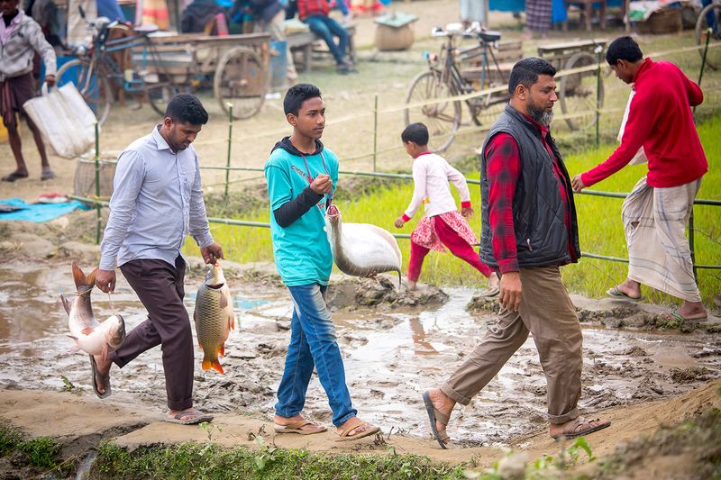 © Jahangir Alam Onuchcha - A family owner is returning home after purchasing a fish from the fair (Poradah Mela) for the family.