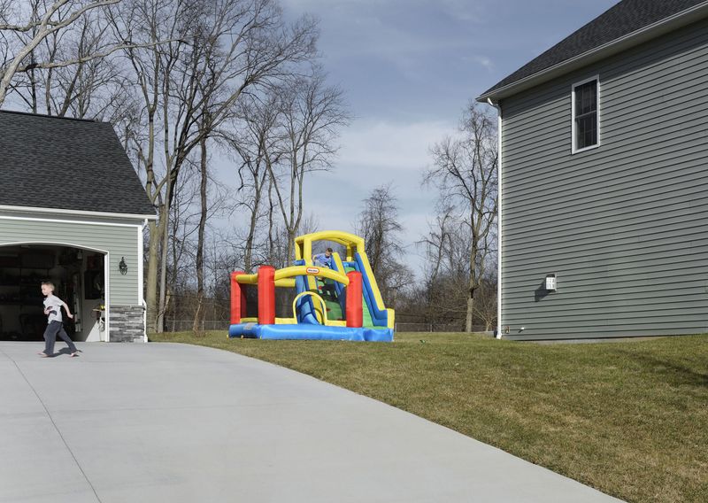 © Graeme Williams - Suburbs of Harrisburg, USA. 2016. The only splash of colour within a monotonous sprawl of houses.