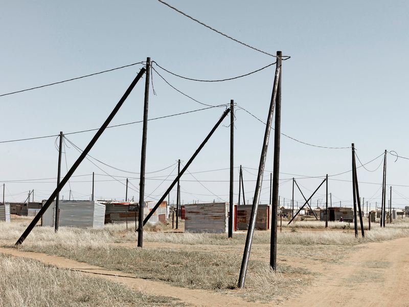 © Graeme Williams - Delareyville, South Africa. 2013. New shack dwellings receive electricity from the state.