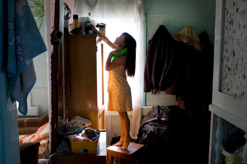 © Marco Pighin - Oymur, Lake Baikal, Buryatya, Siberia, Russian Federation. February 2012. Julya daughter of a local fisherman in her house.