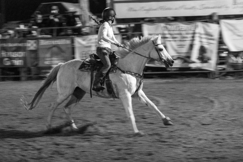 © Rian Nelson - A barrel racer gallops after rounding the third barrel races the the finish line, attempting to get the fastest time.