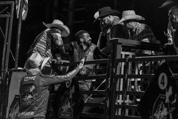© Rian Nelson - A bullrider gets pulled up, second before the bull dislodged him almost pinning the rider under the two ton beast.