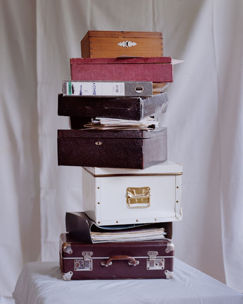 © Matevž Čebašek - Archival boxes and folders containing family photographs and documents.