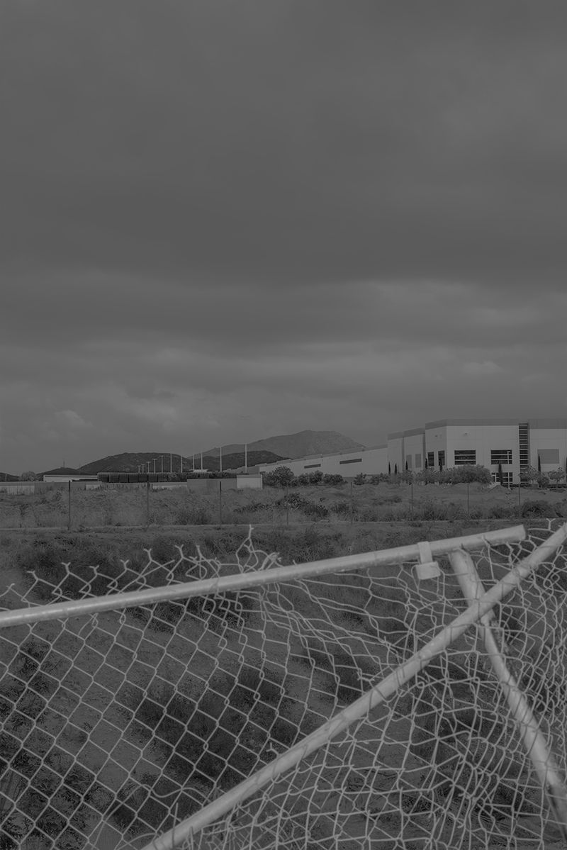 © Vera Saldivar - Amazon Warehouses seen from a backyard in Fontana, California