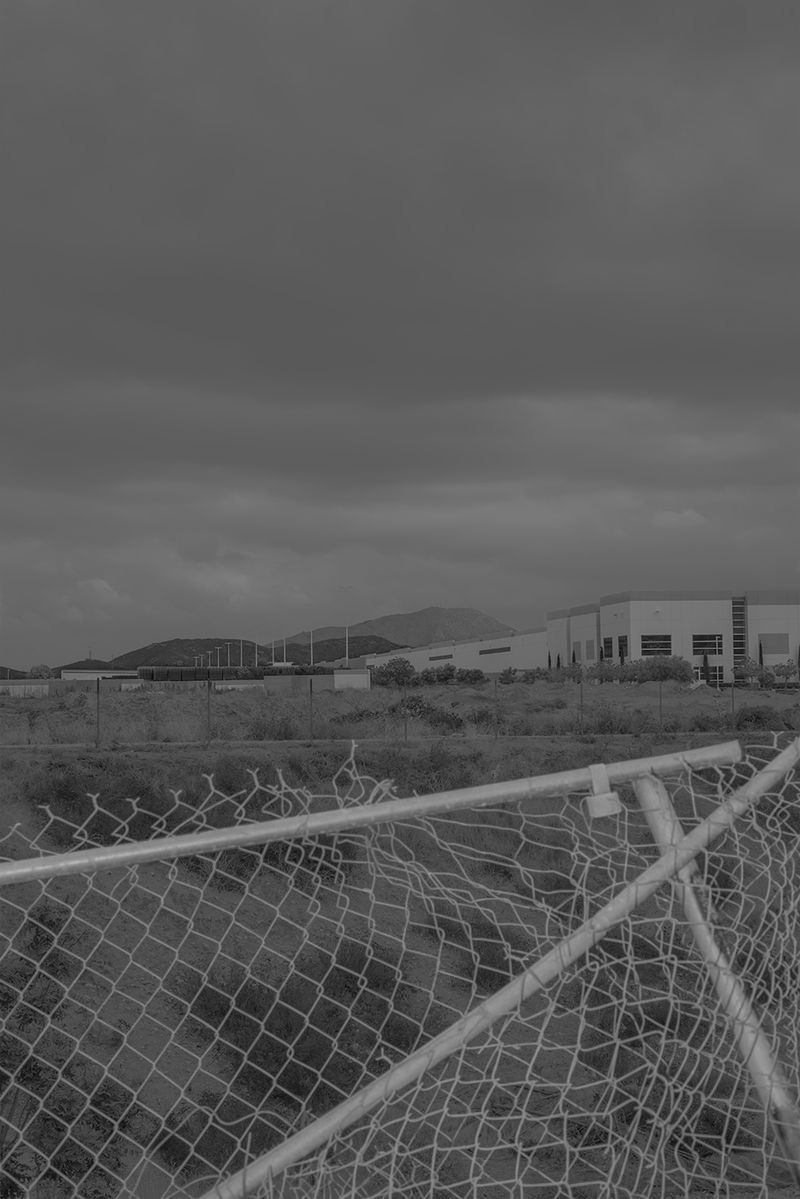 © Vera Saldivar - Amazon Warehouses seen from a backyard in Fontana, California