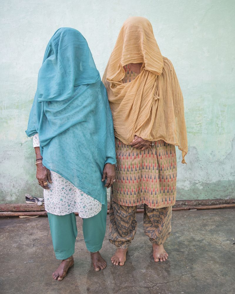 © Alejandra Arévalo - Siddi Janb Umar and her cousin pose in front of their family home in Bedi after attending Mai Misra’s Urs.