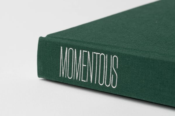 © Byron Co - MOMENTOUS debossed in silver foil onto the spine.