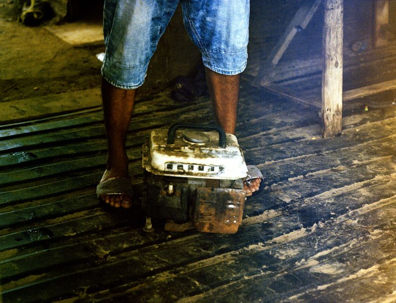 © Kelly-Ann Bobb - Pedro stands with a generator that is no longer working, which was the families only source of electricity.