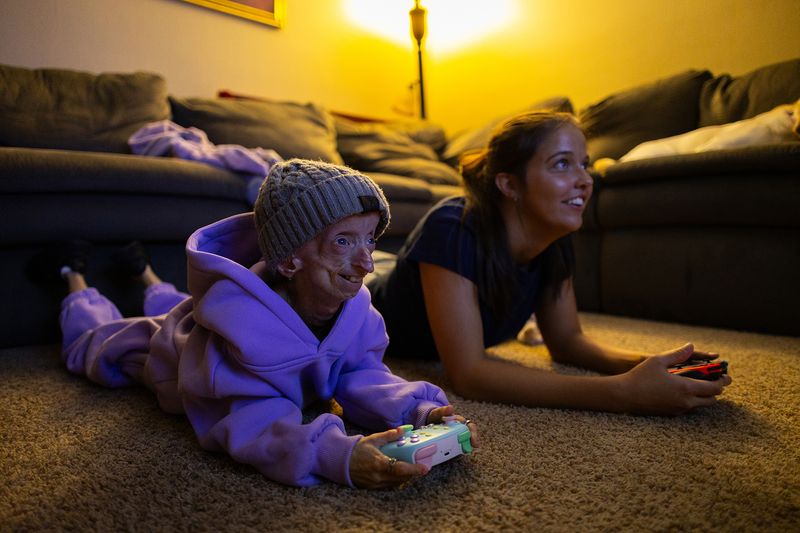© Logan  White - Kaylee and Anna play video games after dinner.