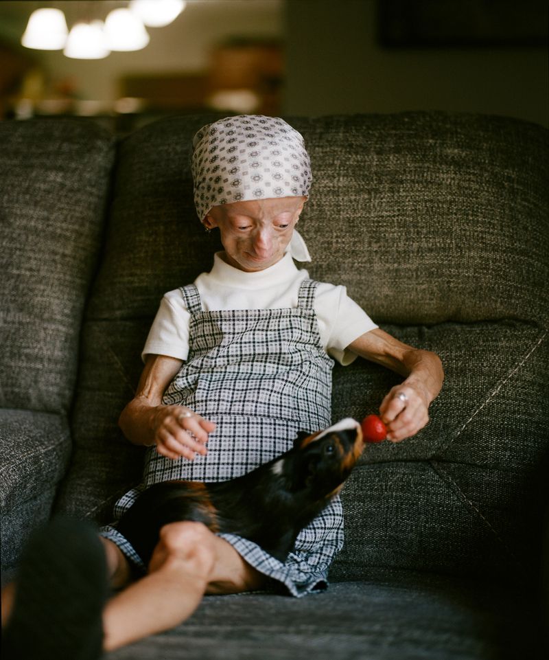 © Logan  White - Kaylee feeds her guinea pig, Lana.