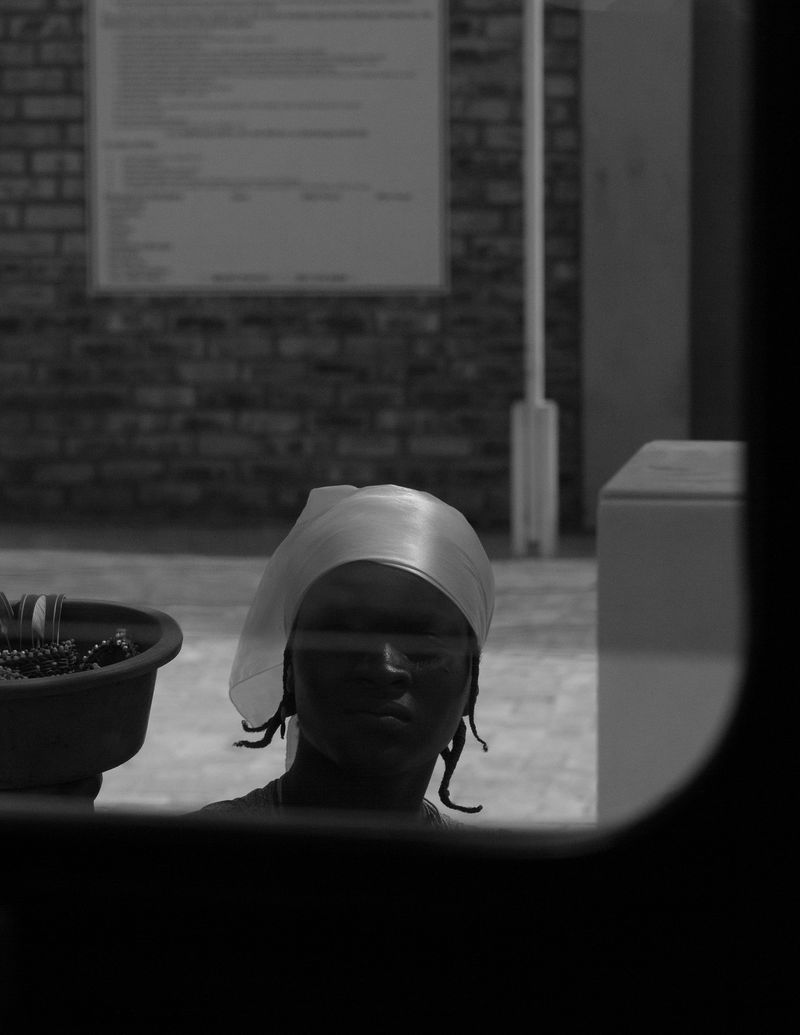 © Reuben - (Untitled #5) A woman sells miscellaneous amenities whilst waiting for petrol in Northern Namibia.