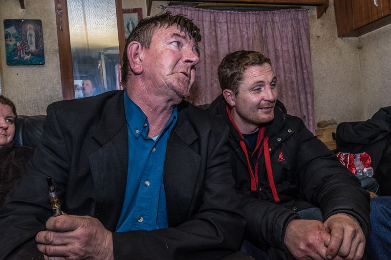 © Stephen Gerard Kelly - John (52) talks with Michael (34) and other Irish Traveller in his caravan.