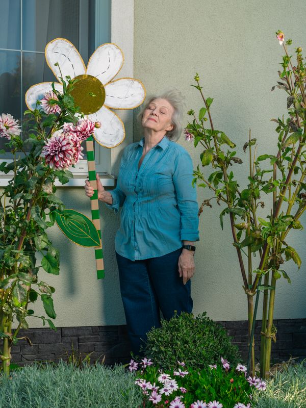 © Maryna Syrovatka - Mrs. Nadia and Her Flowers (far away)