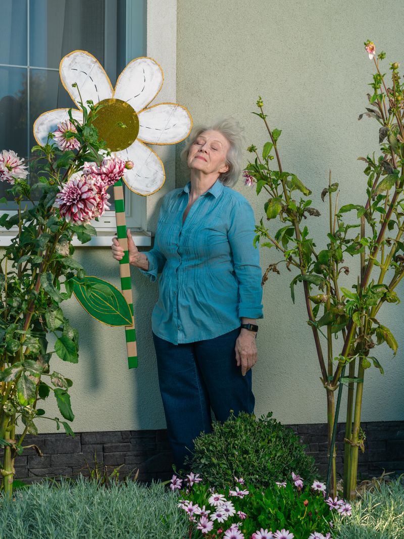 © Maryna Syrovatka - Mrs. Nadia and Her Flowers (far away)