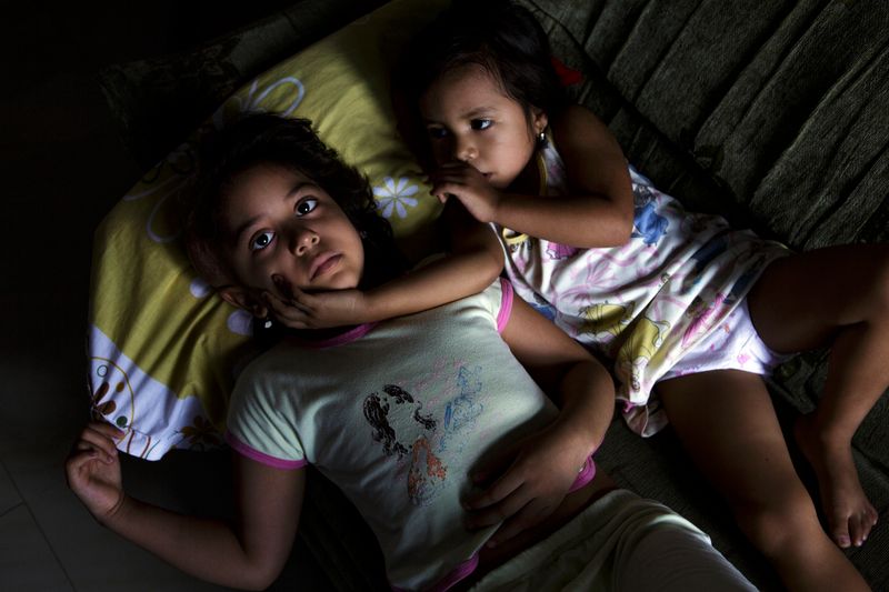 © Allison Hess - Michelle lies with Micaela at their home. On December 17, 2015, Michelle lost her battle with cancer.