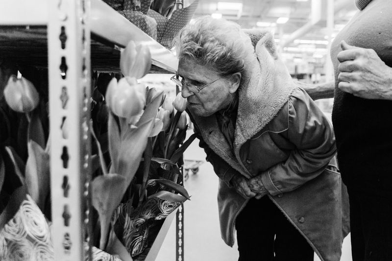 © Allison Hess - While on an outing with Ward and their caretaker, Eloise stops to smell flowers in a store.