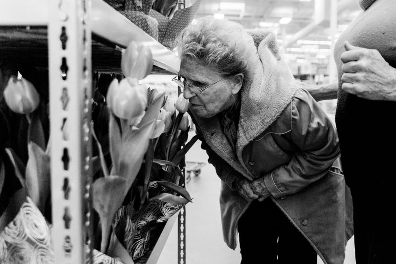 © Allison Hess - While on an outing with Ward and their caretaker, Eloise stops to smell flowers in a store.