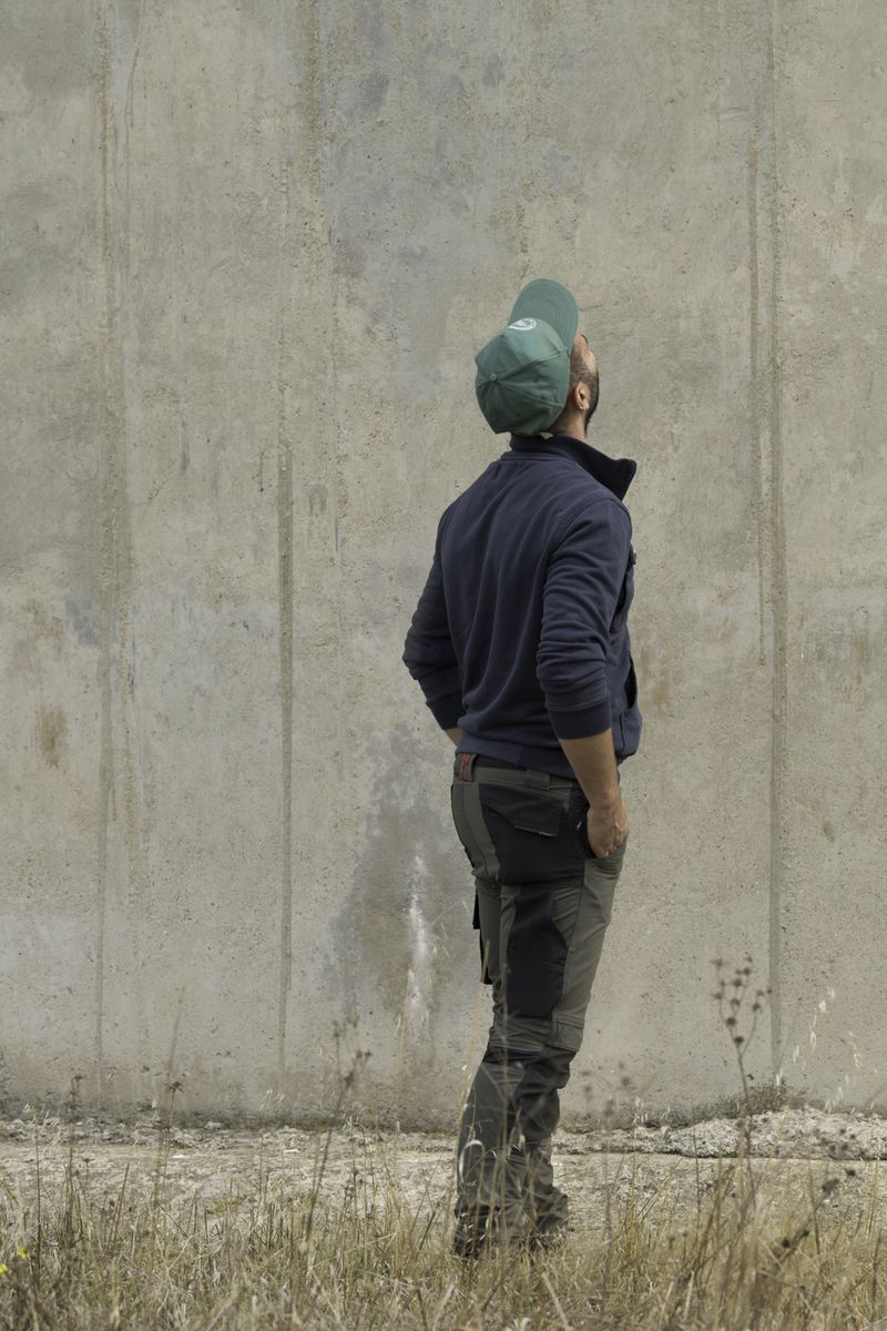 © Giulia Arantxa Novelli - M., giovane pastore, guarda la ciminiera che sovrasta il suo pascolo, al limitare della zona industriale.