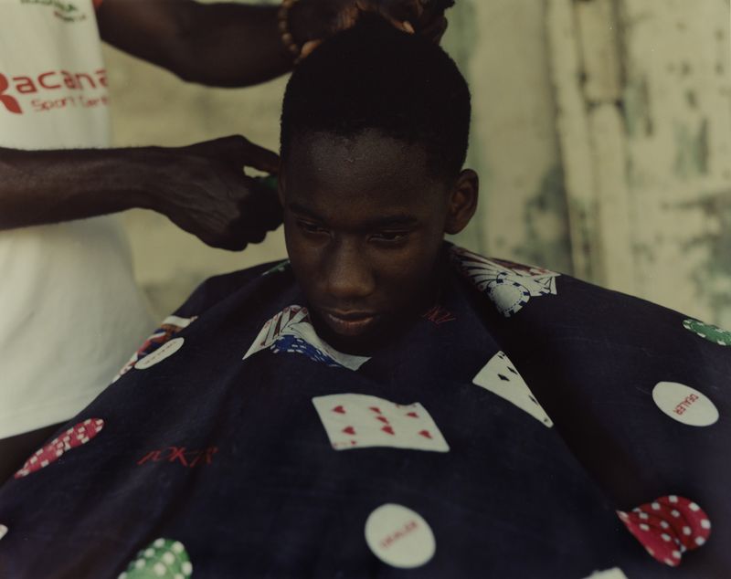 © Cécile Smetana - In order to make some extra money the local barber has set up shop for the weekend in an abandoned house.